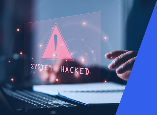 Laptop with warning icon and &ldquo;system hacked&rdquo; display, visualization of cybersecurity risks in IT systems