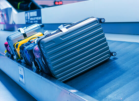 Suitcases on a baggage carousel at the airport